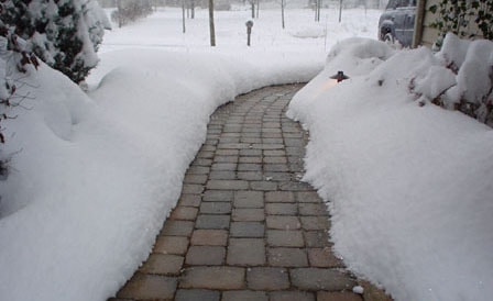 Melt snow and ice in cobblestone sidewalk